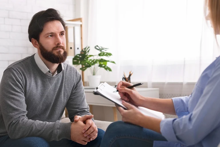 A man asking a specialist how to find the right anxiety treatment center in Pennsylvania