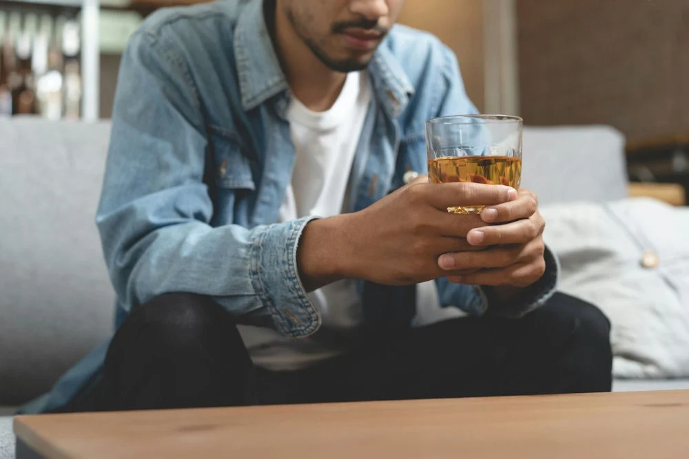 alcohol-addiction-explained a man holding a glass of beer