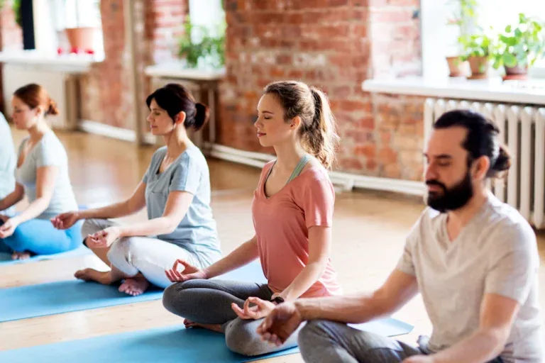 Group of individuals practicing yoga and healing