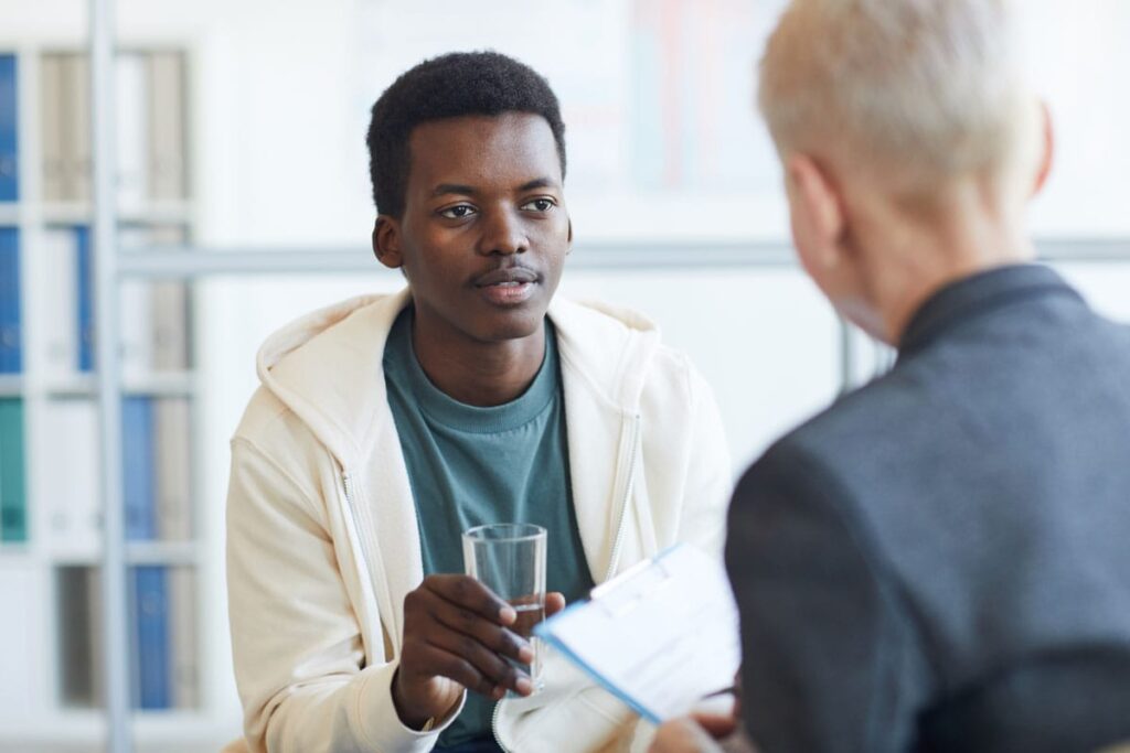 man addressing substance abuse with a young adult seeking Addiction treatment