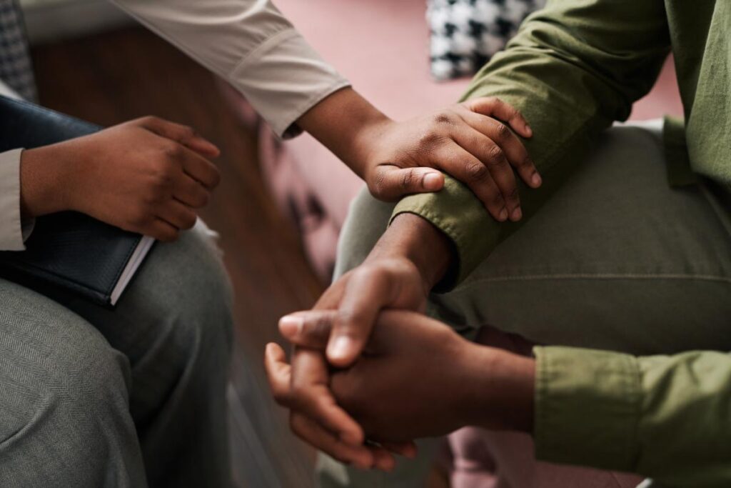a person puts a hand n a loved one's arm as they decide to enter residential program