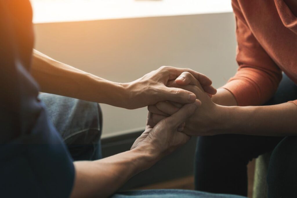 Two people holding hands, three techniques to ease anxiety