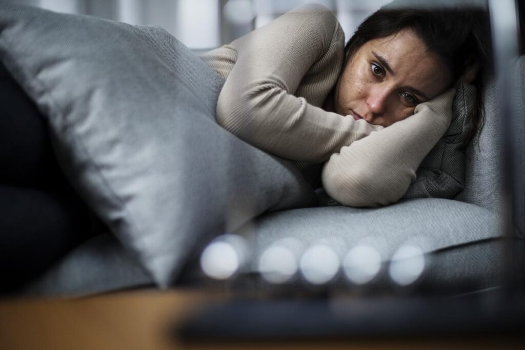Woman lying in bed showing drug addiction symptoms