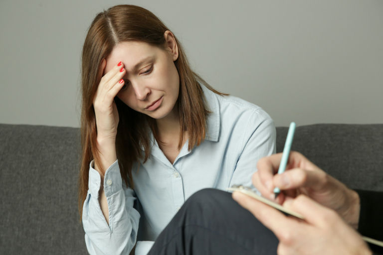 A woman experiencing the physical side effects of detoxing