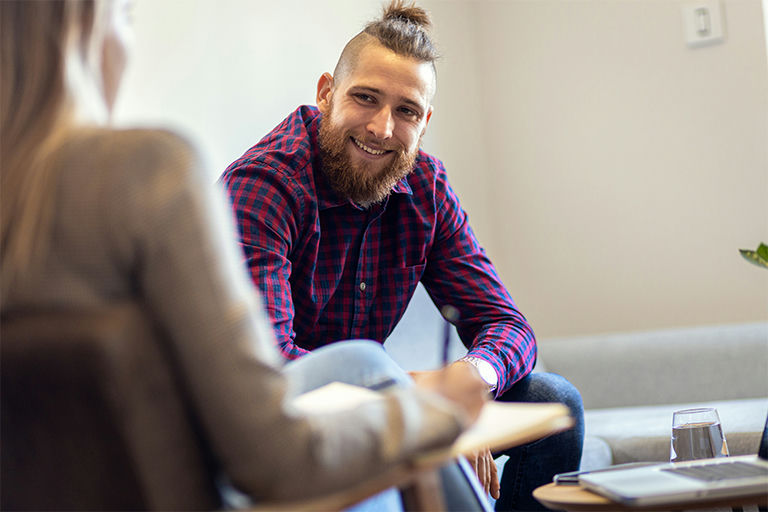 A happy man uses Dialectical Behavior Therapy to help manage PTSD symptoms