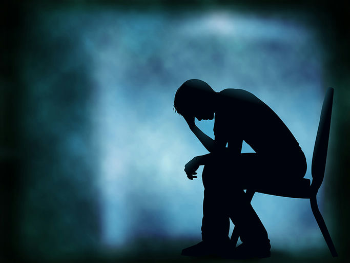 A person sitting on a bench, struggling with depression
