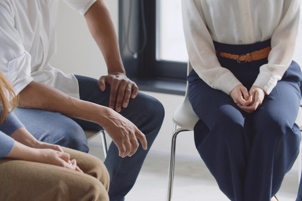 group of men and women sitting in a circle learning how intensive outpatient programs treat substance abuse