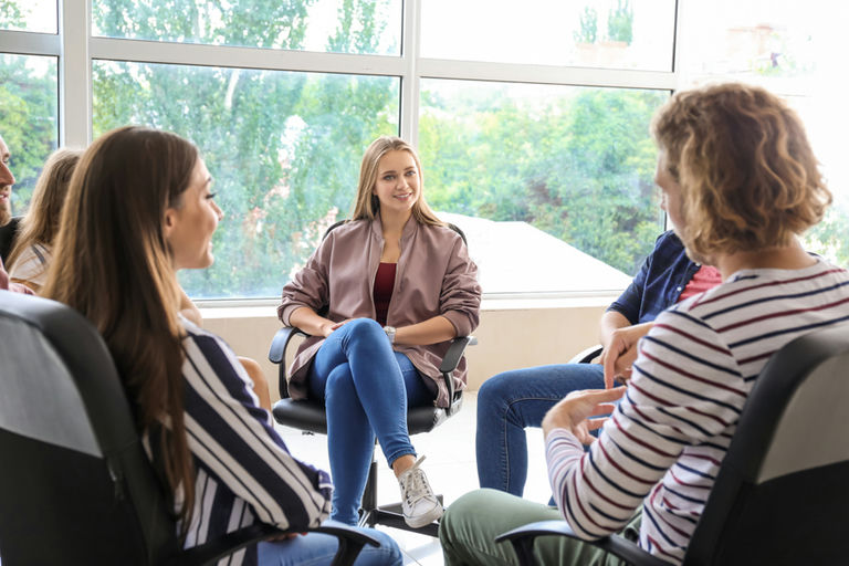 Women participating in a supportive women‑only rehab therapy session focused on healing and recovery
