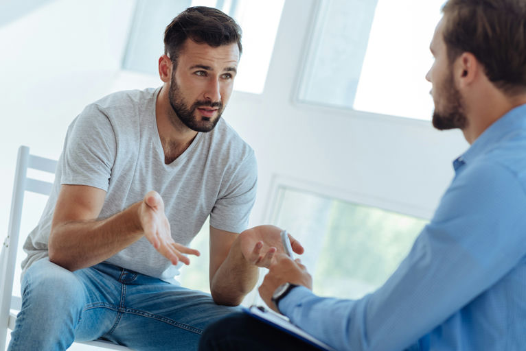 A man asking questions about residential addiction treatment options near Reading, PA