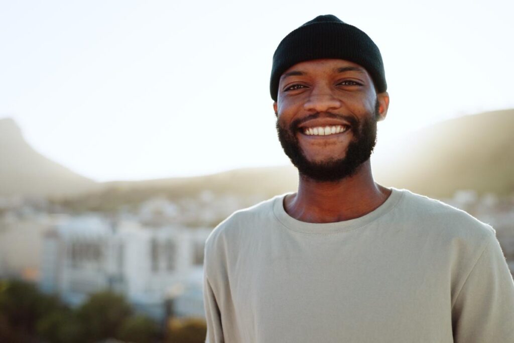 a person smiles to show the benefits of an alcohol detox