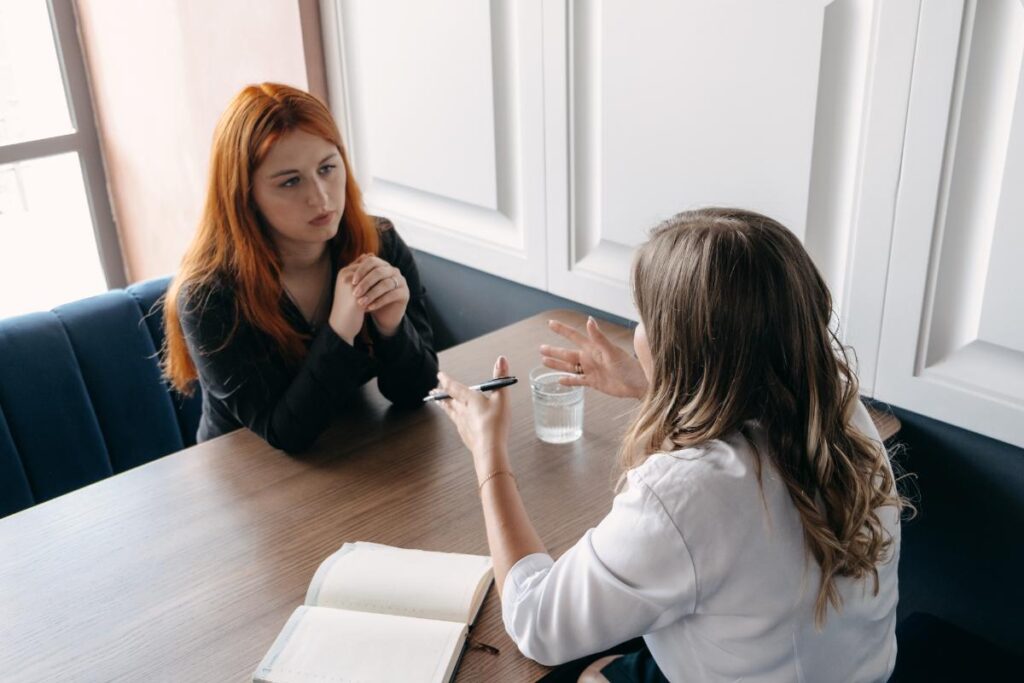 a woman opens up to a counselor in trauma therapy