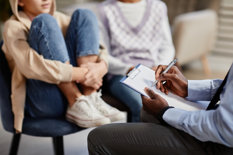 A patient showing common PTSD signs like flashbacks, nightmares, and mood changes