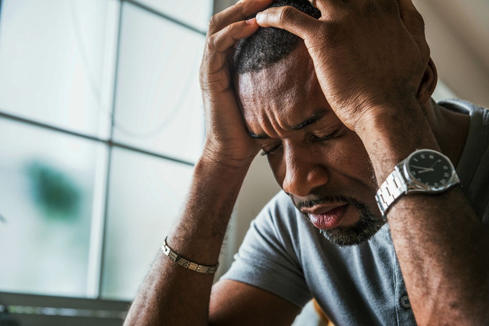 a man with his hands on his head