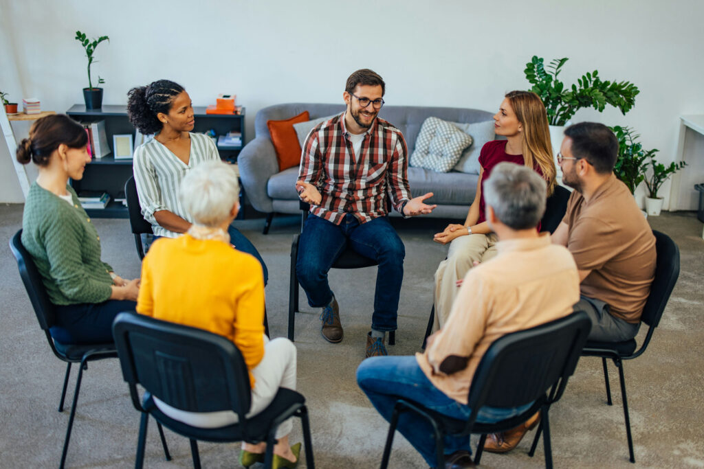 a man speaking in group therapy