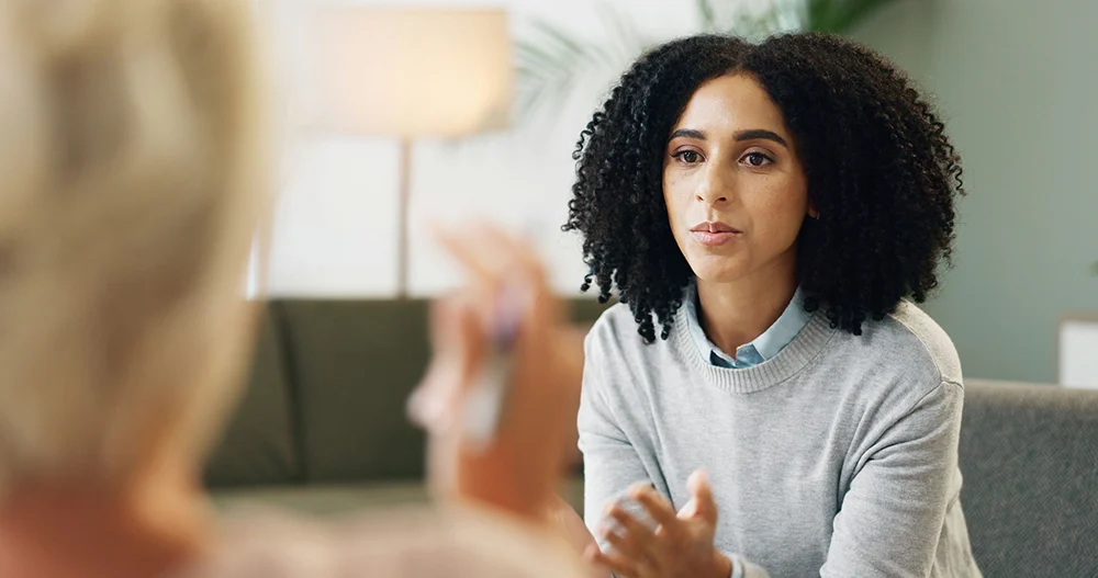 Girl in trauma therapy consulting her therapist during a private session