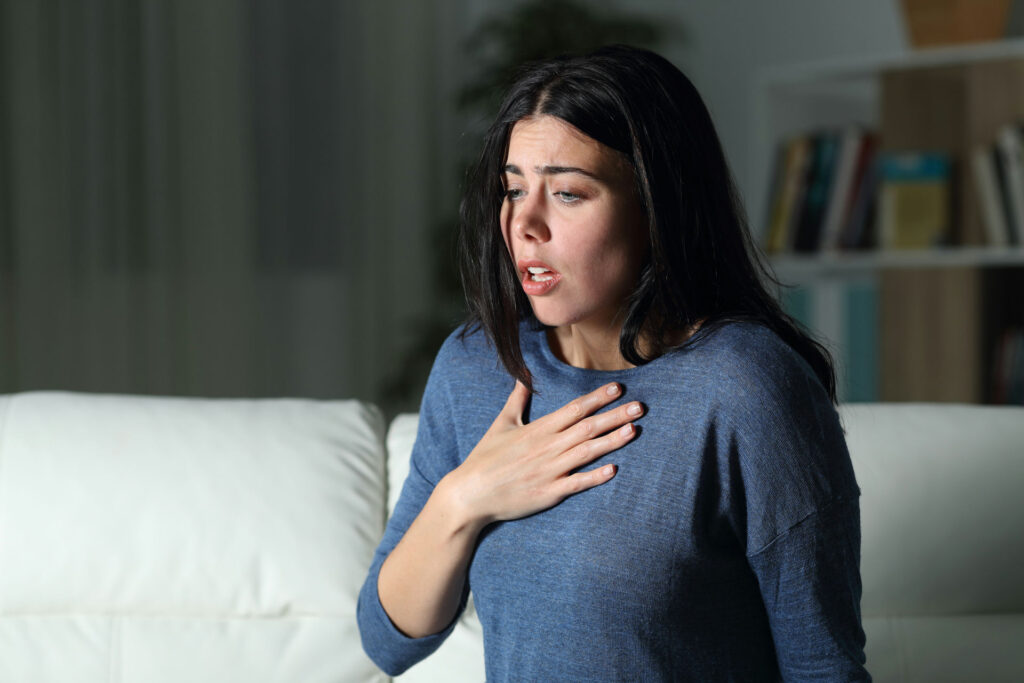 a woman with hand on heart