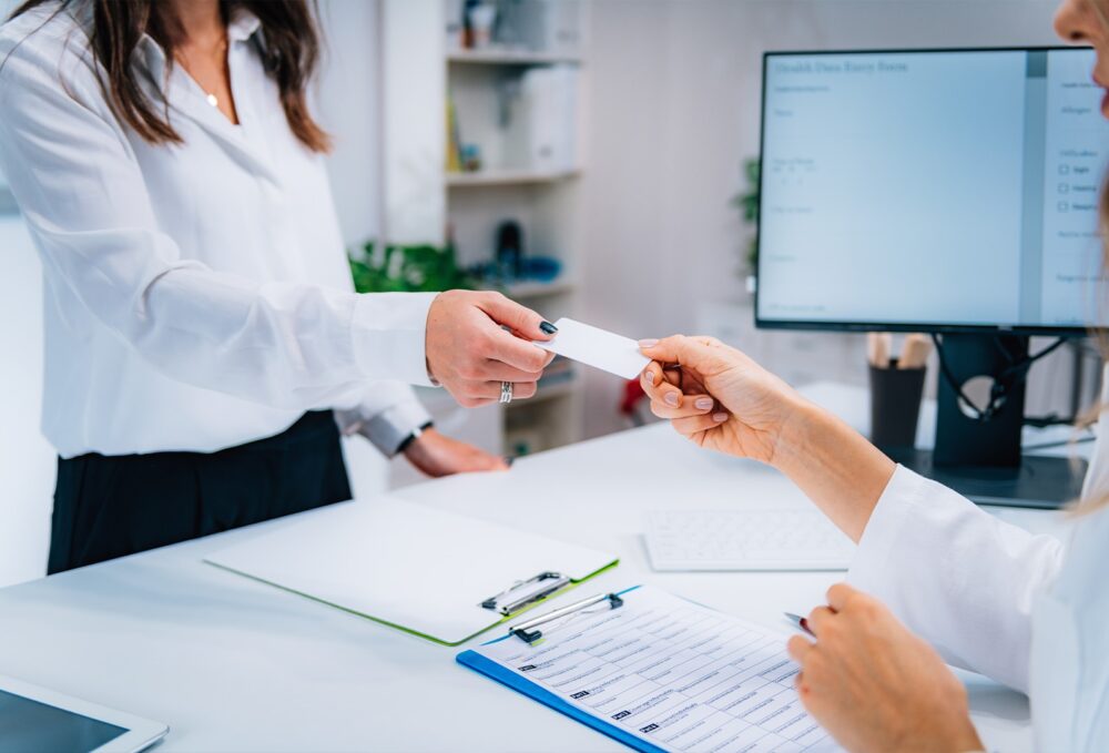 a woman accepting an insurance card
