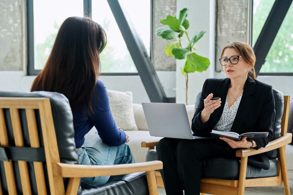 a therapist speaking to her patient