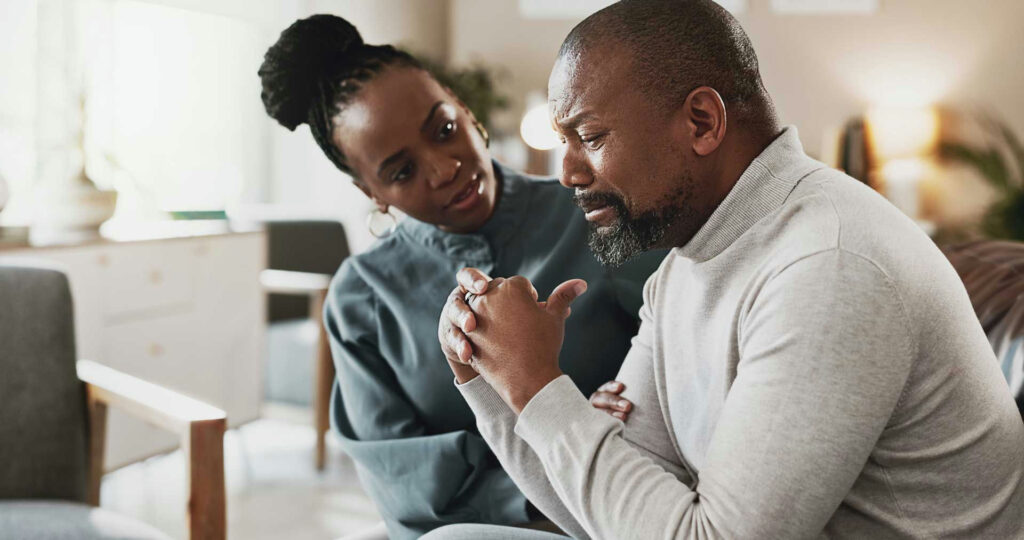 a therapist comforting crying man